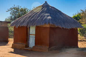 Africa village, mud shack with thatched roof traditional, in the yard