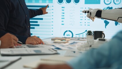 A dynamic scene of humans and a robot collaborating during a business meeting, highlighting data...