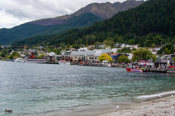 Lakeside Town with Mountains and Boats