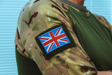 Uniform of a soldier with camouflage pattern and symbols of Great Britain. Close-up military image.