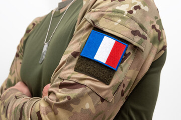 Fototapeta premium French soldier in uniform with camouflage and identification badges on white background.