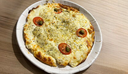 Delicious cheese pizza with tomato and olives on wooden table