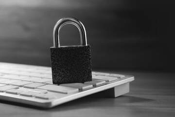 laptop and lock on table, security concept