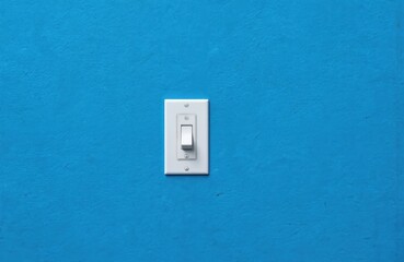 Vibrant blue wall with single white switch mounted installation element. Modern design feature with clean, simple, bright style. Flat top, bottom, single knob, rounded ends of switchplate against