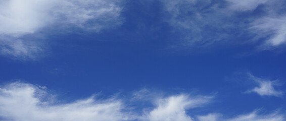 Light blue azure sky. White fluffy clouds along the edges. Background template. Frame border. Clear sunny summer day. Cleanliness purity freshness freedom peace concept. Design. Wide banner. Panoramic