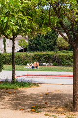 Woman Reading on Grass in Valencia Park