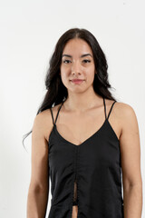 Young latin woman posing in studio with white background