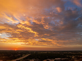 Drone view of dramatic sunset seen above over-55 community near Georgetown in Texas