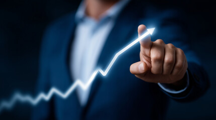 Businessman in a suit pointing at rising arrow graph, concept of financial growth, success and upward trend, futuristic blue background business analytics, performance increase, co
