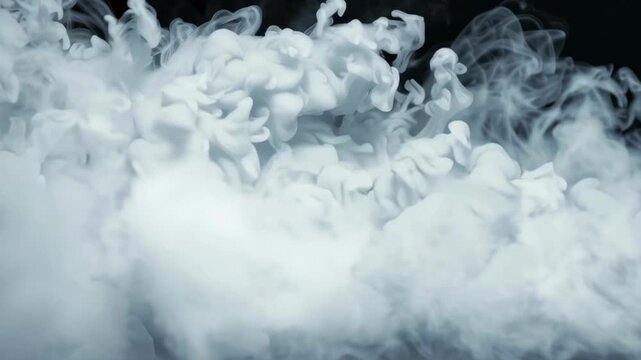 A black and white photo of smoke with a grayish color. The smoke is thick and dense, creating a sense of heaviness and darkness. The image evokes a feeling of mystery and uncertainty