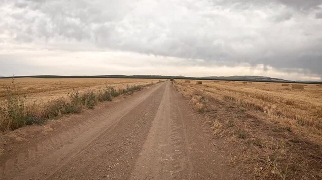 Camino Mozarabe de Santiago - a dirt road through summer farm fields between Antequera and Cartaojal, province of Malaga, Andalusia, Spain