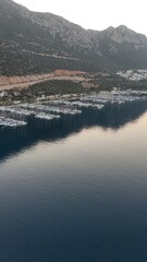 Coastal mountain landscape, sea resort yachts, golden hour