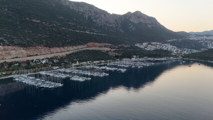 Obraz premium Coastal mountain landscape, sea resort yachts, golden hour