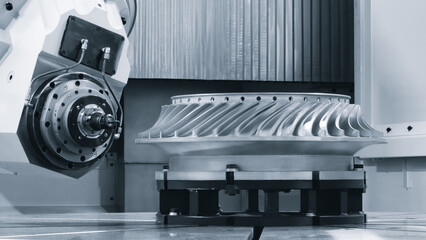 Large metal turbine on table of industrial metalworking programmable CNC machine, industrial machine concept background © Aleksandr Matveev