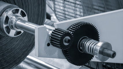Two black metal gears as a conveyor or industrial machine drive, industrial concept background