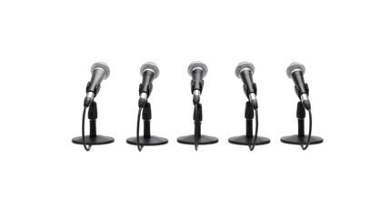 Five microphones lined up, ready for speakers, creating a professional and engaging atmosphere.