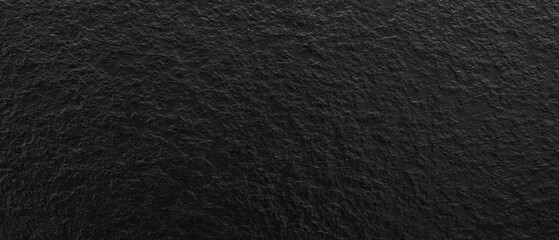 Dark black rough textured abstract background.