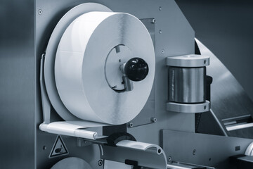 Fragment of the conveyor of sticking labeling machine. Abstract industrial background