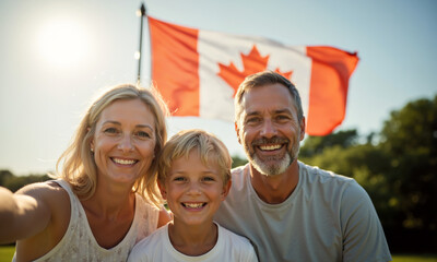 Happy Canadian family taking a selfie with national flag outdoors. Mother, father, and son smiling on Canada Day. Canada Day celebration, 1st July