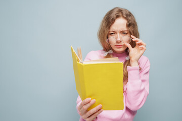 Woman in Glasses Struggling to Read Book with Poor Vision