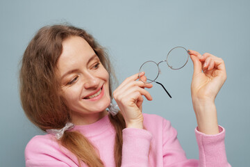 Smiling Woman Holding Vision Glasses for Clear Eyesight and Correction