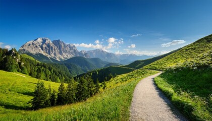 serene landscape with a curved pathway through lush greenery and majestic mountain range under vibrant blue sky