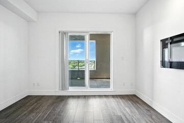 Fototapeta premium Large open living room with a large window and a white wall