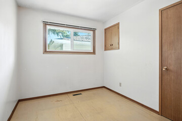 Small, empty room with a window and a door