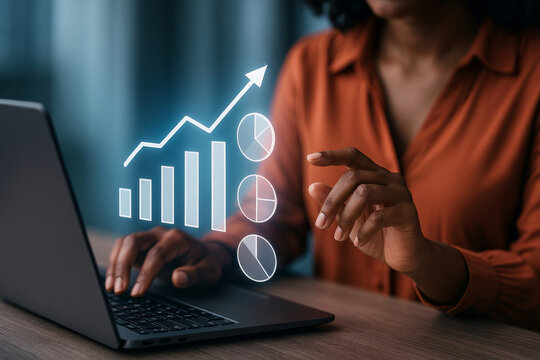 Black businesswoman analyzing financial growth with digital bar and pie chart graphics on laptop