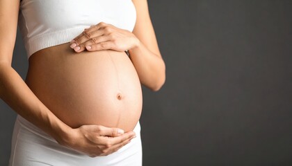 Pregnant Woman Holding Her Belly on Gray Background
