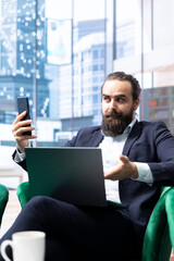 Fototapeta premium Skilled empowered male CEO negotiating with shareholders on online call, asking for more funds to sustain an expansion project. Businessman director driven for success, leadership skills.