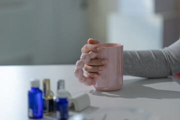 Sophisticated light manicure on elegant hand, beauty salon scene with luxury tools visible