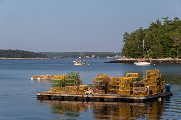 Lobster traps piled up on a dock near McFarland's Cove on Johns River in South Bristol, Maine, on a late summer afternoon