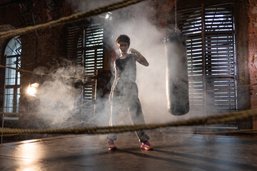 champion pose, throw your fist up, you're a winner, the mood of a motivating sports story, cinematic look.athletic woman in the boxing ring