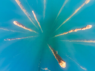 A mesmerizing underwater landscape: the tops of sunken trees in Rummu quarry, descending into the abyss of the purest turquoise water of Estonia.