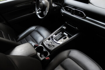 Top view of the front seats and interior elements of the car completely covered in elegant leather 