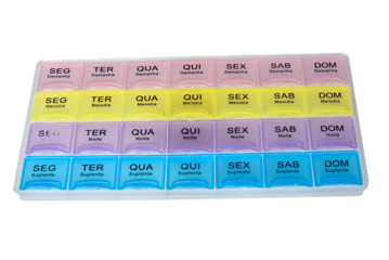 organized pill box with name in Portuguese of the days with pills isolated on white background