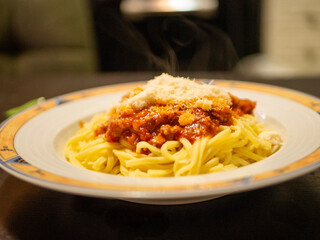 pasta bowl with bolognaise sauce and chese with hot fumes comming off