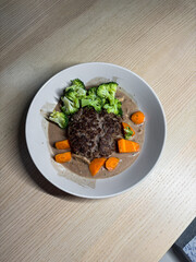 A plate of hamburg steak with creamy sauce.