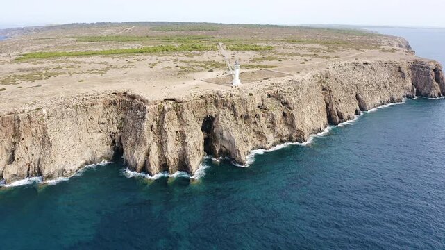 Aerial view of the impressive lighthouse on the cliffs of Cape Barbaria, on the island of Formentera, Spain.