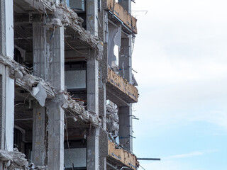 Urban demolition reveals skeletal structure of a high-rise building in disrepair