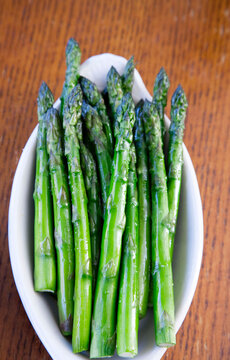 Fresh Steamed Asparagus Spears in a White Ceramic Bowl