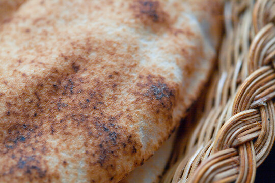 Rustic Close-Up of Warm Toasted Flatbread in Woven Basket