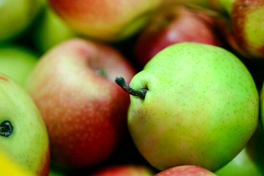 A colorful and crisp close-up of assorted red apples and green pears, showcasing natural textures and fresh ripeness