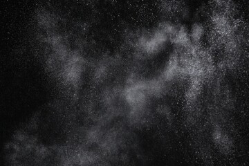 Fototapeta premium Ethereal dust cloud against a dark backdrop creating a dramatic and mysterious atmosphere reminiscent of distant galaxies or a cosmic event