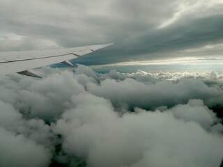Fototapeta premium Flying through Summer Clouds over the Pacific Ocean near Tokyo, View from Airplane Window