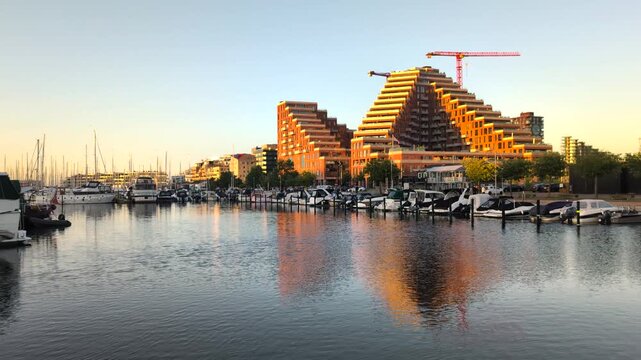 Aarhus, Denmark - July 18, 2025: Aarhus Marina and sailsport area. View of sailboats at Aarhus harbor. New built city called the docklands in central Aarhus, Denmark. Evening Sun on Boats in Harbor 