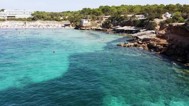 Aerial view of the small huts where the fishermen of Cala Saona keep their fishing boats, in Formentera, Spain.