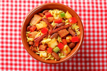Baião de Dois in a ceramic bowl, a typical dish of Brazilian northeastern cuisine with rice, beans, jerked beef and curd cheese