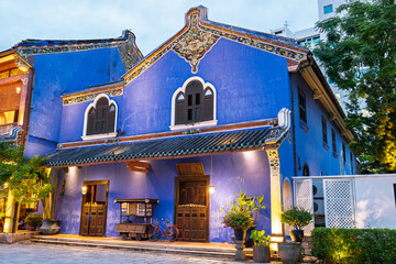 A vibrant blue-painted building illuminated at night, showcasing colonial architecture and cultural charm in the heart of the UNESCO World Heritage city.